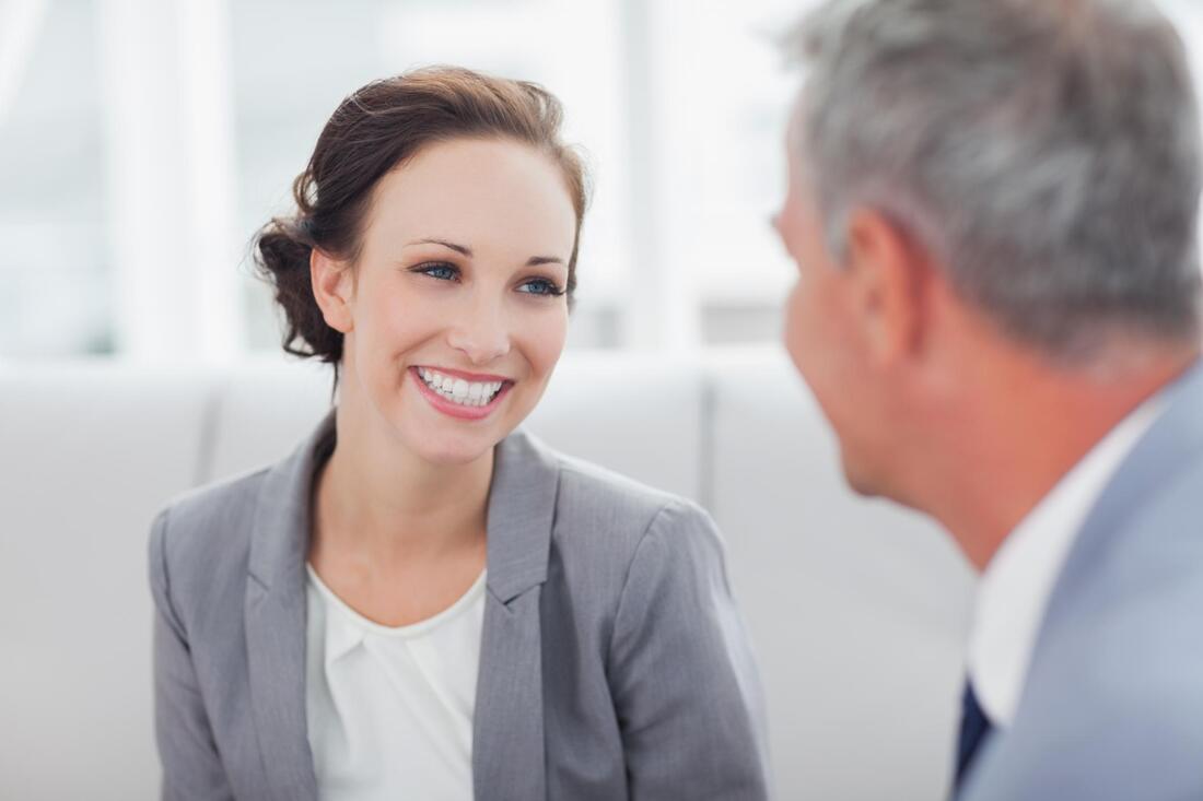 woman is smiling while facing the man